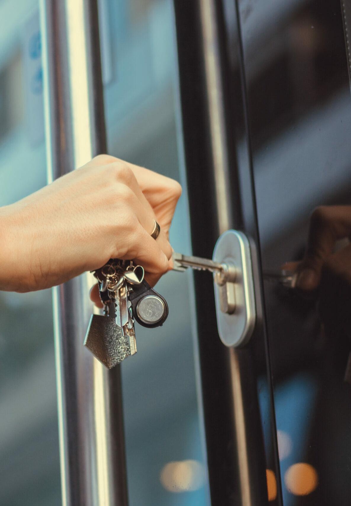 Close,Up,Of,Woman,Unlocking,Entrance,Door,With,A,Key.